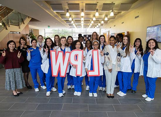 Group of 澳门新普京注册 nursing students holding the letters LPW